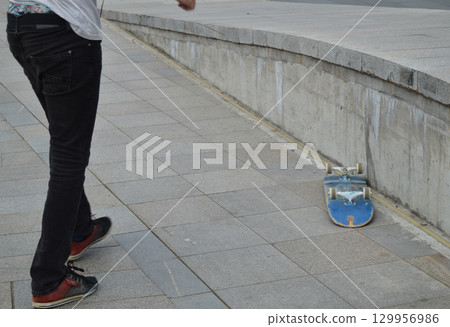 skateboard, a man doing tricks and flips 129956986