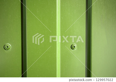 Green industrial background self-drilling in corrugated sheet close-up Green industrial background self-drilling in corrugated sheet close-up 129957022