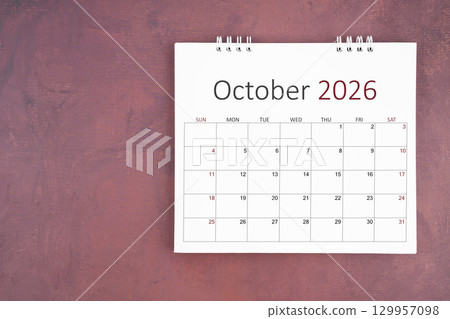 October 2026 desk calendar on red cement wall background. Page of annual monthly calendar for plan. October 2026 desk calendar on red cement wall background. Page of annual monthly calendar for plan. 129957098