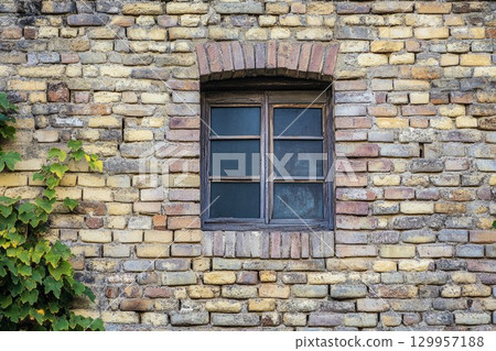Rustic brick wall with small window close-up. Neural network AI generated 129957188