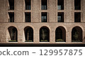 Symmetrical brick arches against soft light. Neural network AI generated 129957875