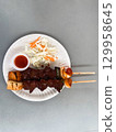 Grilled beef skewers with vegetables and sauce served as Thai street food. Concept of culture, flavor, nutrition, community, tradition and lifestyle. 129958645
