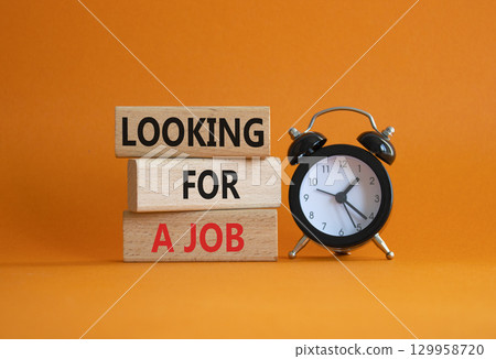 Looking for a job symbol. Concept words Looking for a job on wooden blocks. Beautiful orange background with alarm clock. Business and Looking for a job concept. Copy space. Looking for a job symbol. Concept words Looking for a job on wooden blocks. Beautiful orange background with alarm clock. Business and Looking for a job concept. Copy space. 129958720