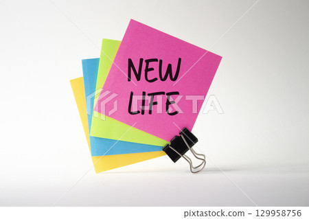New life symbol. Pink sticky note with concept words New Life. Beautiful white background. Business and New life concept. Copy space. 129958756