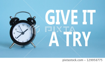Give it a try symbol. Beautiful blue background with alarm clock. Business and Give it a try concept. Copy space. 129958775