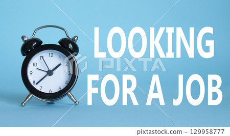 Looking for a job symbol. Beautiful blue background with alarm clock. Business and Looking for a job concept. Copy space. 129958777