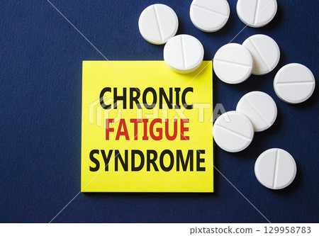 Chronic Fatigue Syndrome symbol. Concept word Chronic Fatigue Syndrome on yellow note. Beautiful deep blue background with pills. Medicine and Chronic Fatigue Syndrome concept. Copy space 129958783