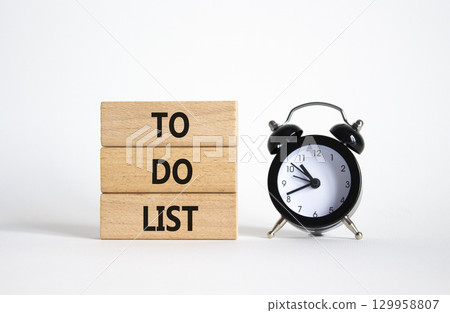 To Do List symbol. Concept words To Do List on wooden blocks. Beautiful white background with alarm clock. Business and To Do List concept. Copy space To Do List symbol. Concept words To Do List on wooden blocks. Beautiful white background with alarm clock. Business and To Do List concept. Copy space 129958807