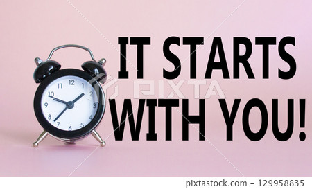 It starts with you symbol. Beautiful pink background with alarm clock. Business and It starts with you concept. Copy space. 129958835
