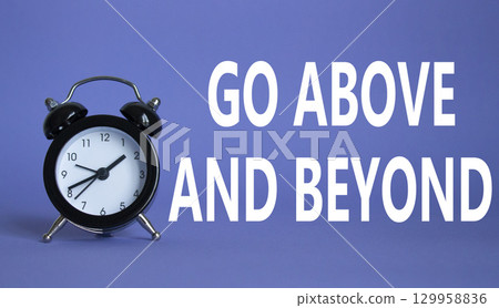 Go above and beyond symbol. Beautiful purple background with alarm clock. Business and Go above and beyond concept. Copy space. Go above and beyond symbol. Beautiful purple background with alarm clock. Business and Go above and beyond concept. Copy space. 129958836