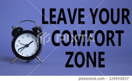 Leave your Comfort Zone symbol. Beautiful purple background with alarm clock. Business and Leave your Comfort Zone concept. Copy space. 129958837
