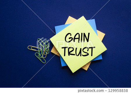 Gain trust symbol. Gain trust on sticky note. Beautiful deep blue background. Business and Gain trust concept. Copy space. Gain trust symbol. Gain trust on sticky note. Beautiful deep blue background. Business and Gain trust concept. Copy space. 129958838