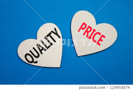 Price or Quality symbol. Concept word Price or Quality on wooden hearts. Beautiful blue background. Business and Price or Quality concept. Copy space Price or Quality symbol. Concept word Price or Quality on wooden hearts. Beautiful blue background. Business and Price or Quality concept. Copy space 129958874