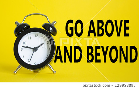 Go above and beyond symbol. Beautiful yellow background with alarm clock. Business and Go above and beyond concept. Copy space. 129958895
