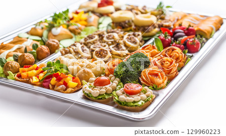 Assorted appetizer platter vibrantly displayed. Assorted appetizer platter vibrantly displayed. 129960223