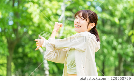 在綠地中伸展身體的女人 129960799