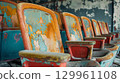 Weathered stadium seats with peeling paint 129961108