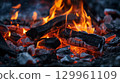Glowing embers and flames of campfire 129961109
