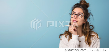 Thoughtful woman with pen in contemplation Thoughtful woman with pen in contemplation 129961167