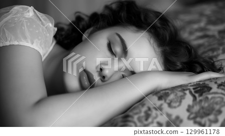 Young woman peacefully sleeping in bed 129961178