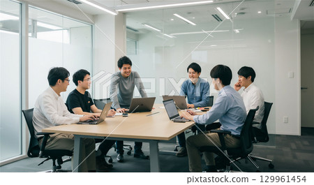Business team meeting in conference room | Modern office work scene using computers 129961454