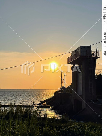 A floodgate bathed in the setting sun 129961459