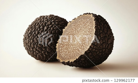 Fresh black truffle with cross section showing texture and pattern detail 129962177