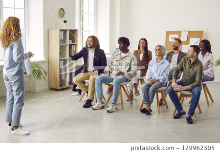 Woman speaker having business training in the office in front of a group of company employees. Woman speaker having business training in the office in front of a group of company employees. 129962305