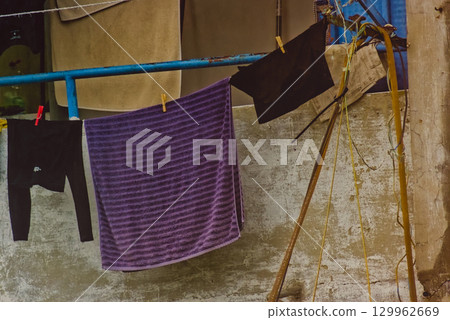 clothes on a hanger near the iron door 129962669