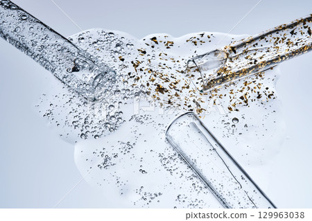 Three test tubes with spilled serums. Demonstration of textures. 129963038