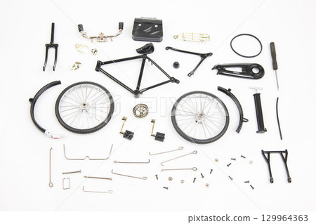 Bicycle parts neatly arranged for assembly or repair on a white background 129964363