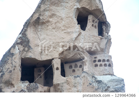 Unique rock formations with ancient cave dwellings in Turkey's captivating landscape 129964366