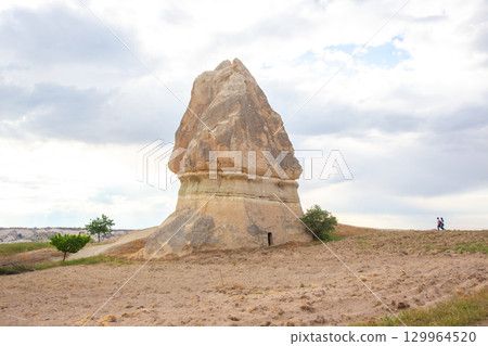 Majestic rock formation rises in Cappadocia, Turkey, under a cloudy sky 129964520