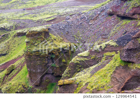 Majestic green moss-covered cliffs of Iceland reveal unique geological formations 129964541