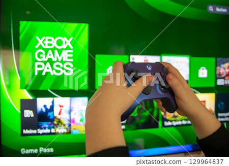 Joystick controller in the hand. Gaming consoles the Xbox Series X and Xbox Series S. For play video games. 129964837