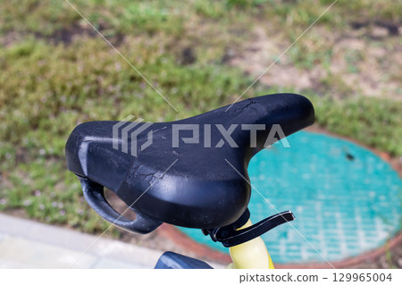 A CloseUp of a Bicycle Seat Captured on a Bright Sunny Day A CloseUp of a Bicycle Seat Captured on a Bright Sunny Day 129965004