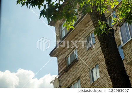 Modern Urban Apartment Building Under Clear Blue Sky 129965007