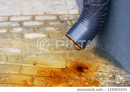 Rust Stains from the Downspout on Paver Surface and Texture 129965034