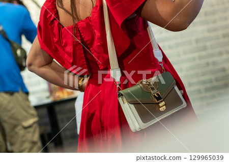Elegant Fashion Statement: Red Dress with Stylish Handbag 129965039