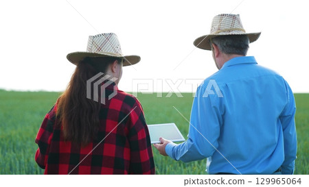 Digital farming partnership, Problem solving on the farm, Agri-business innovation, Field experts at work, Modern equipment on the field, Cutting-edge farming, Successful rural business, New 129965064