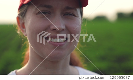 Agriculture, Rural woman smiling in wheat field at dusk, agriculture happiness, farm life close-up, female farming success, outdoor rural portrait, golden field background, sunset farming moment 129965087