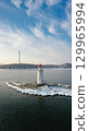 Aerial view of the lighthouse in winter in the ice at dawn 129965994