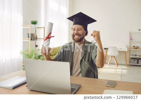 Happy Graduate Online Celebrates with Diploma and Laptop Happy Graduate Online Celebrates with Diploma and Laptop 129966017