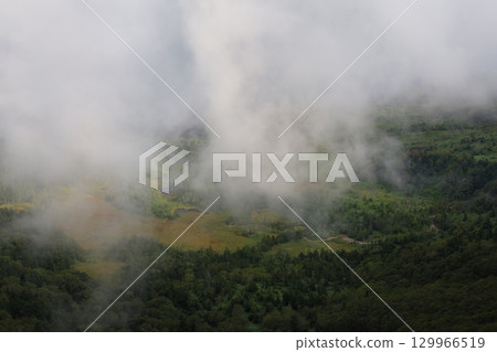 Mountain ridges shrouded in mist 129966519