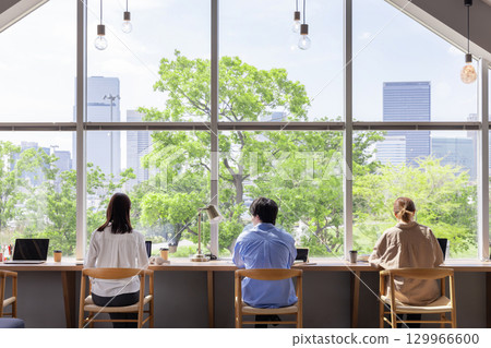 Designer's office, fresh greenery, buildings, blue sky, windows 129966600