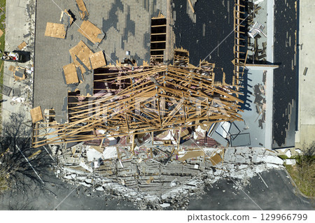 Hurricane Ian destroyed house roof and walls in Florida residential area. Natural disaster and its consequences Hurricane Ian destroyed house roof and walls in Florida residential area. Natural disaster and its consequences 129966799