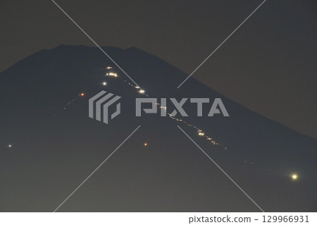 Mount Fuji sunrise climbers' trail of light 129966931