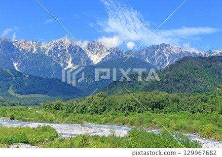 The Northern Alps in summer as seen from the foot of Mt. Hakuba 129967682