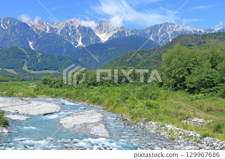 The Northern Alps in summer as seen from the foot of Mt. Hakuba 129967686