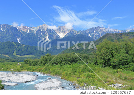 The Northern Alps in summer as seen from the foot of Mt. Hakuba 129967687